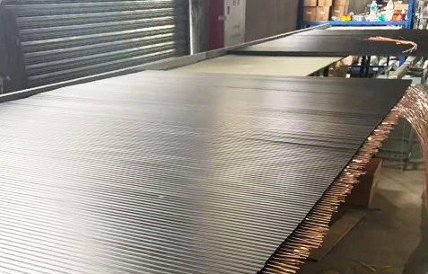 Track lighting rails in a factory production setting.